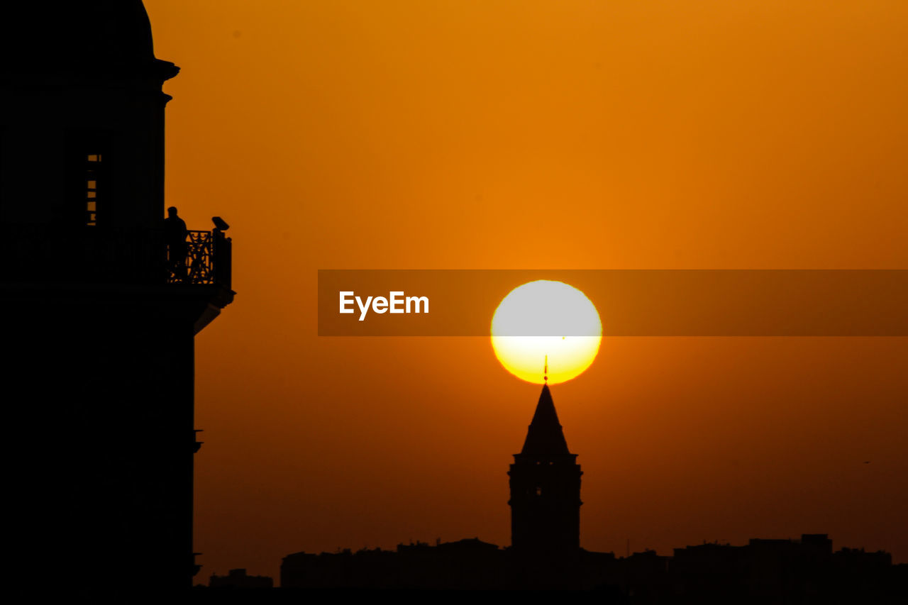 Silhouette galata tower against clear sky during sunset