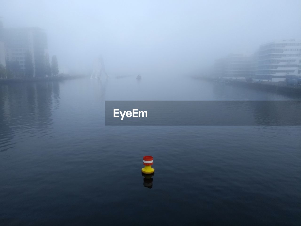 Scenic view of river spree in city berlin on foggy day