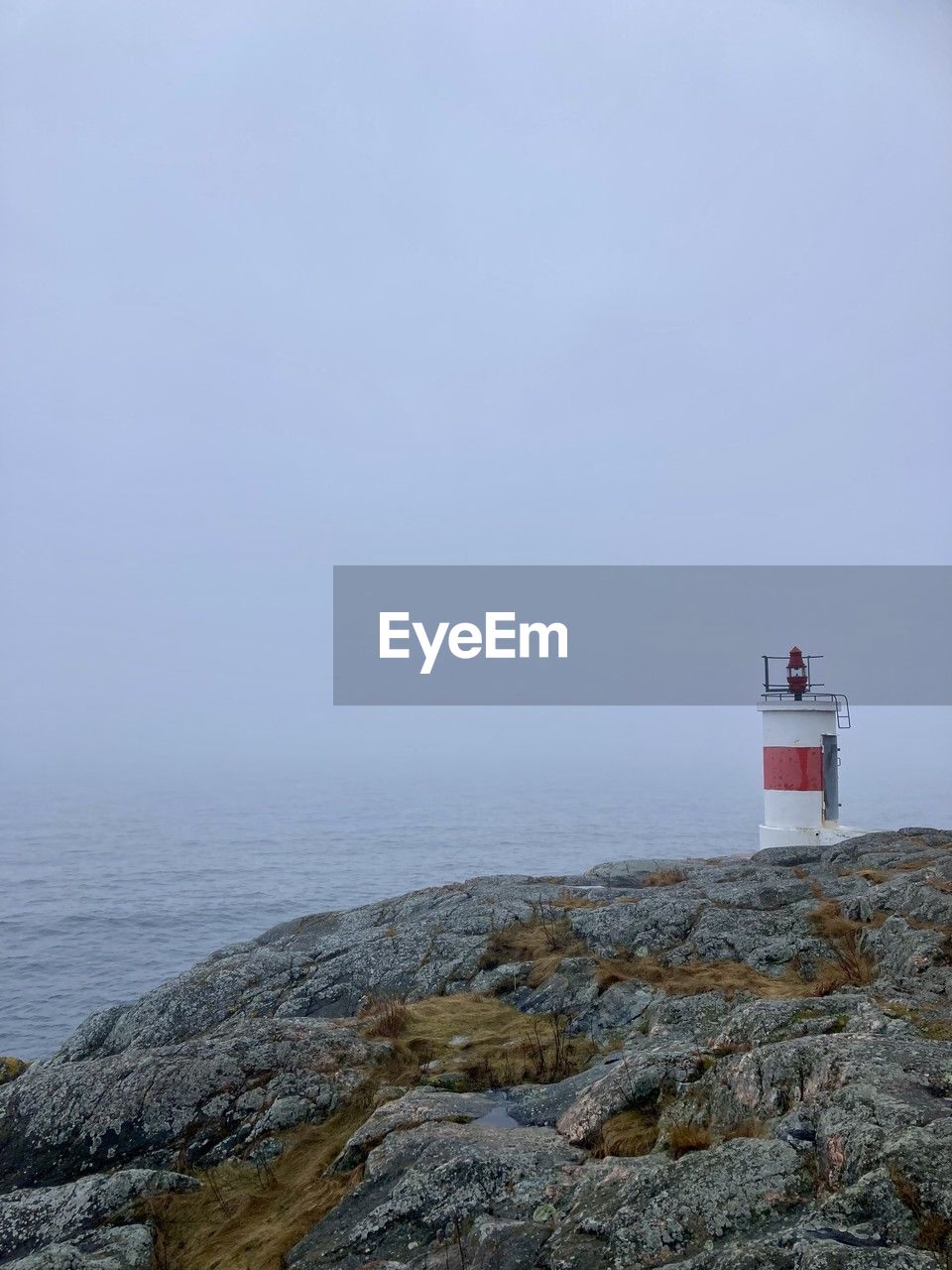 guidance, lighthouse, tower, sea, water, security, protection, architecture, sky, built structure, coast, building exterior, building, beach, nature, ocean, rock, scenics - nature, land, no people, horizon, horizon over water, shore, beauty in nature, tranquility, coastline, day, copy space, travel destinations, outdoors, tranquil scene, travel, non-urban scene, cloud, environment, cliff, landscape, clear sky