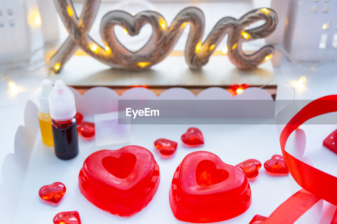 red, heart, valentine's day, heart shape, font, no people, love, food and drink, sweet food, positive emotion, sweet, food, celebration, emotion, indoors, candle, candy