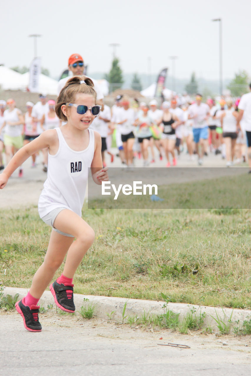 FULL LENGTH OF BOY WEARING SUNGLASSES ON LAND