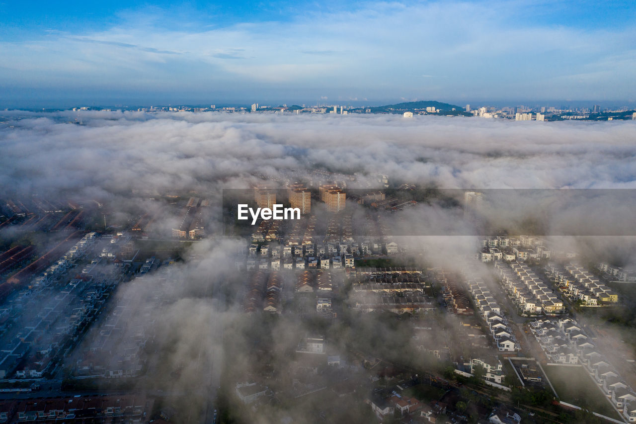High angle view of a town covered by a sea of clouds