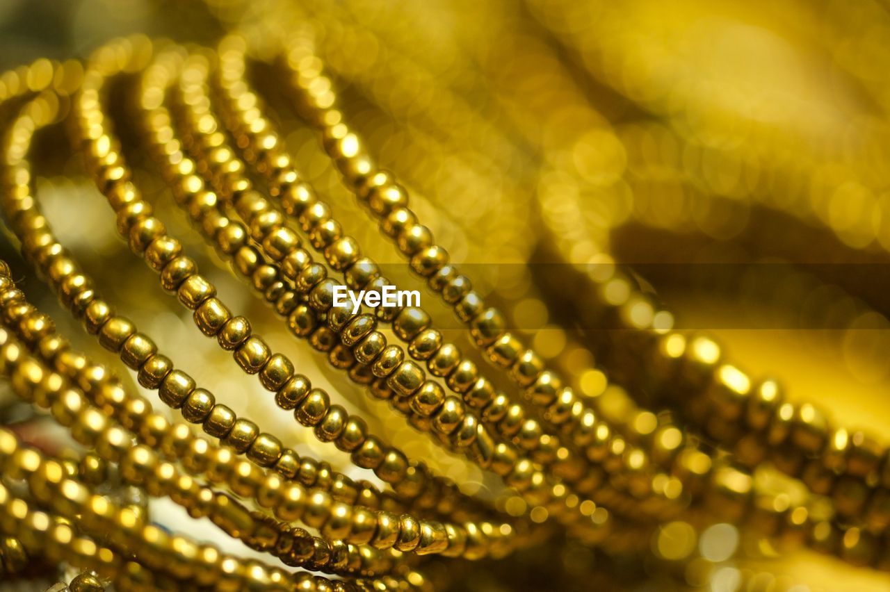 Close-up of golden jewelries on table