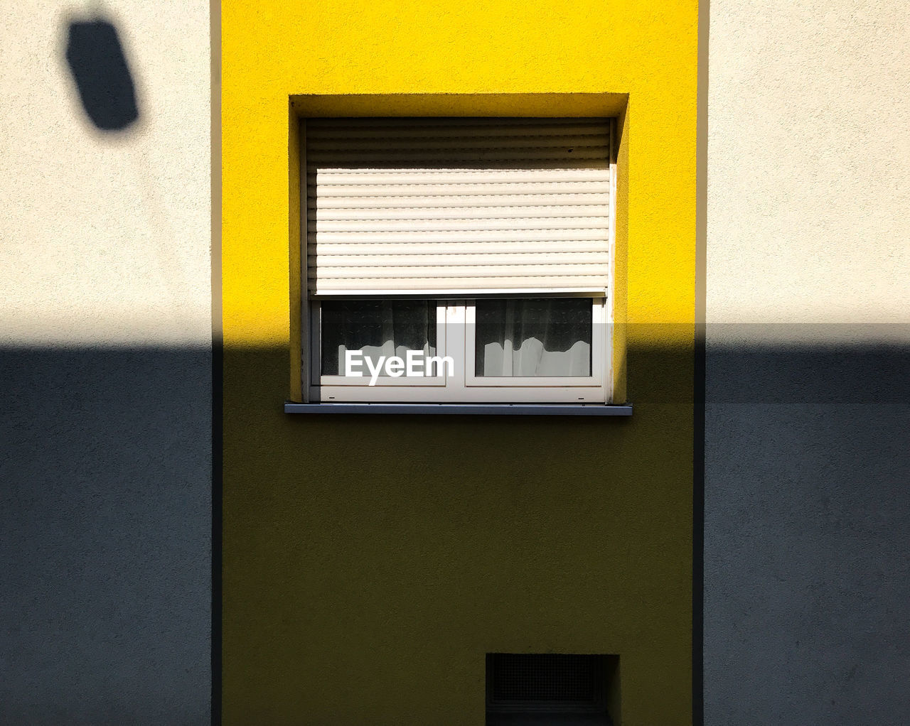 Close-up of yellow window on wall