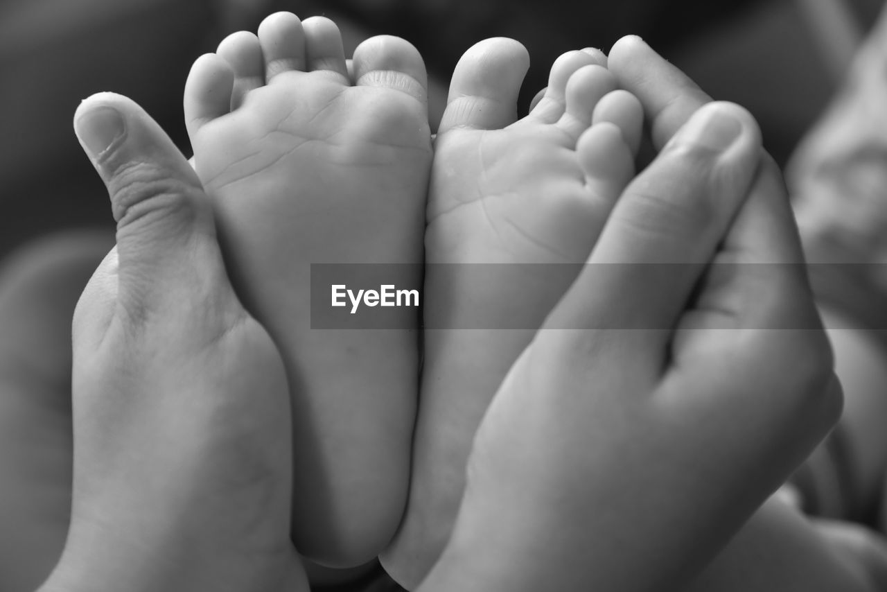 close-up, child, human foot, black and white, human leg, barefoot, hand, childhood, baby, family, toddler, togetherness, limb, monochrome photography, adult, women, finger, toe, bonding, monochrome, indoors, female, love, emotion, parent, sole of foot, human limb, person, positive emotion, low section, lifestyles, two people, newborn, relaxation, arm