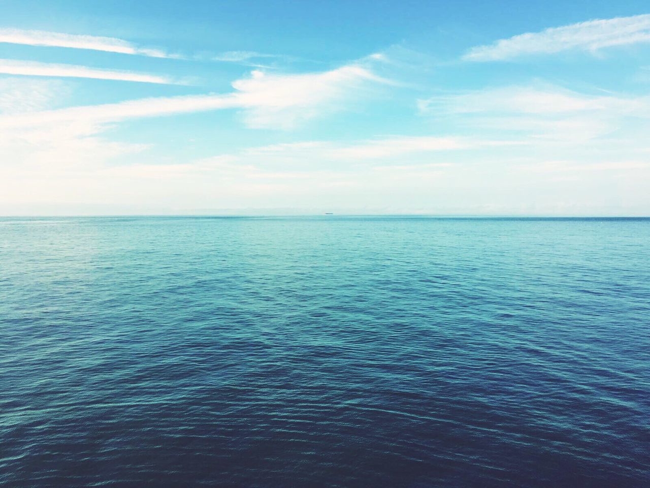 Scenic view of seascape against blue sky