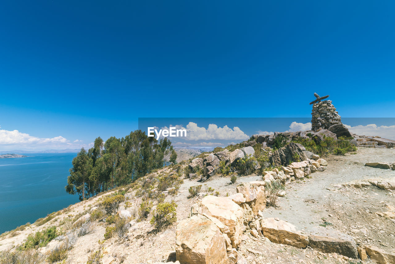 Scenic view of beach against blue sky