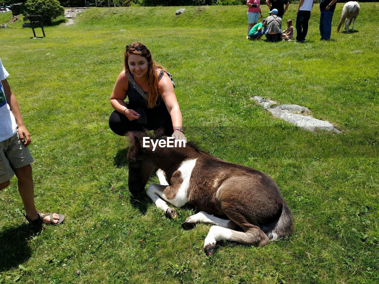 TWO PEOPLE SITTING ON FIELD