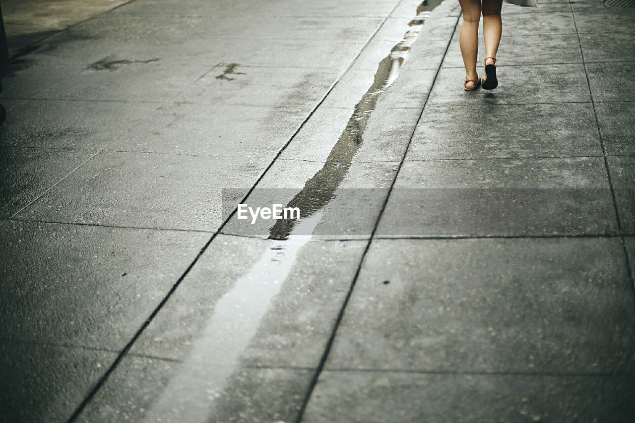 Woman on wet pavement