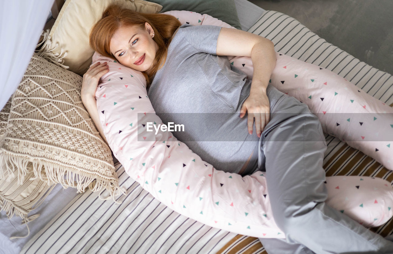 high angle view of woman lying on bed