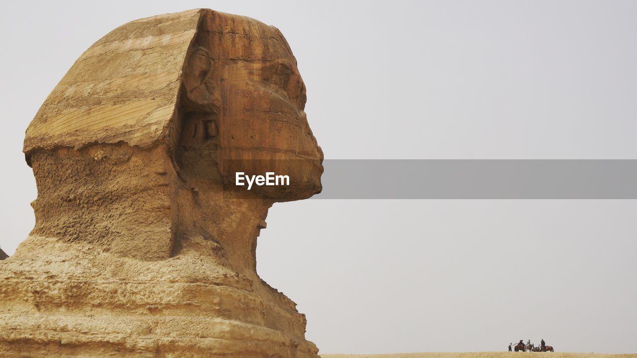 Tourists at the sphinx against clear sky