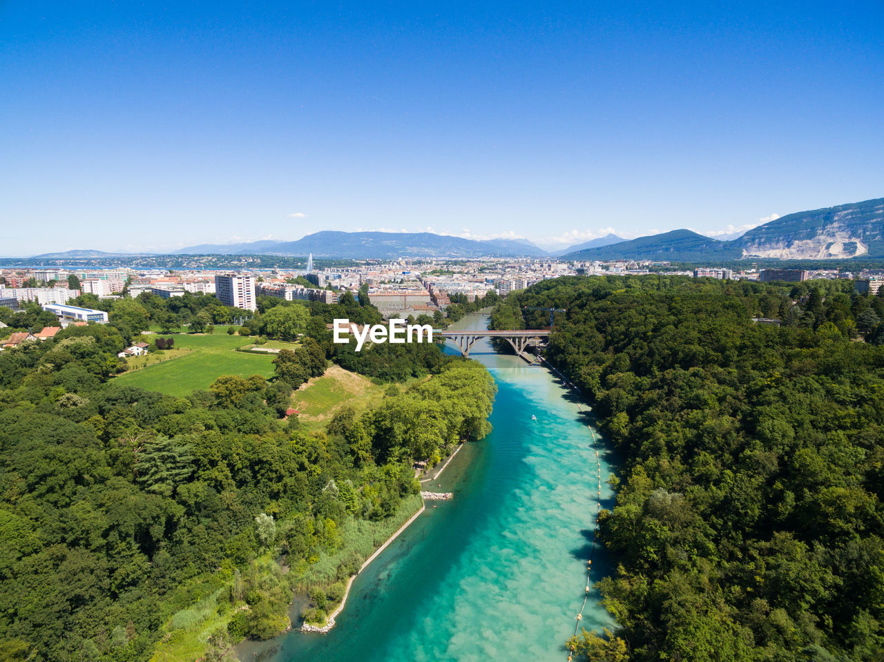HIGH ANGLE VIEW OF CITYSCAPE AGAINST BLUE SKY