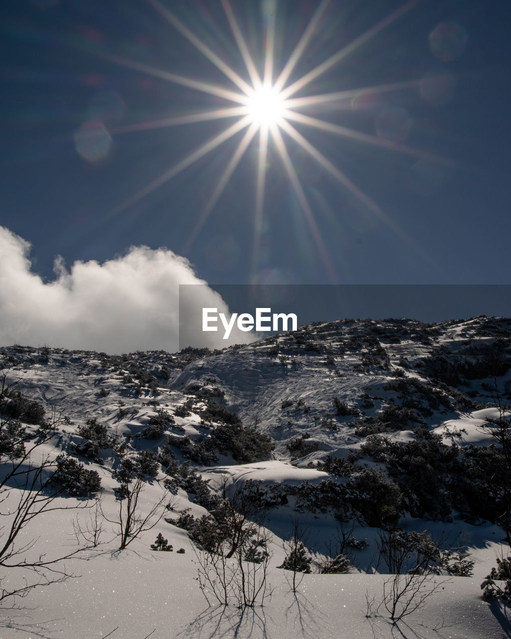 Scenic view of snow covered mountains against sky