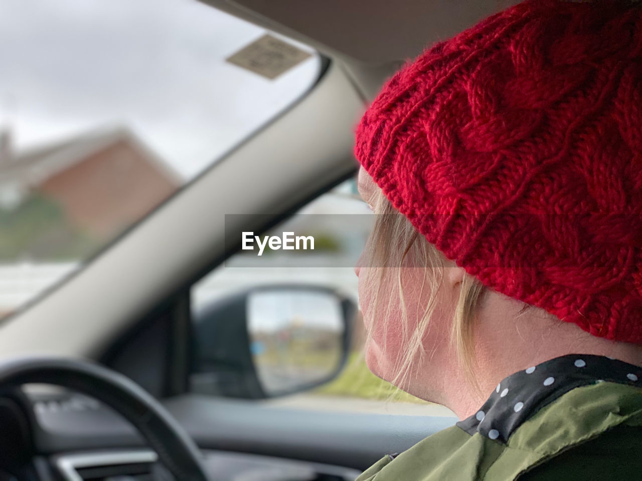 Woman driving a car wearing a knit hat