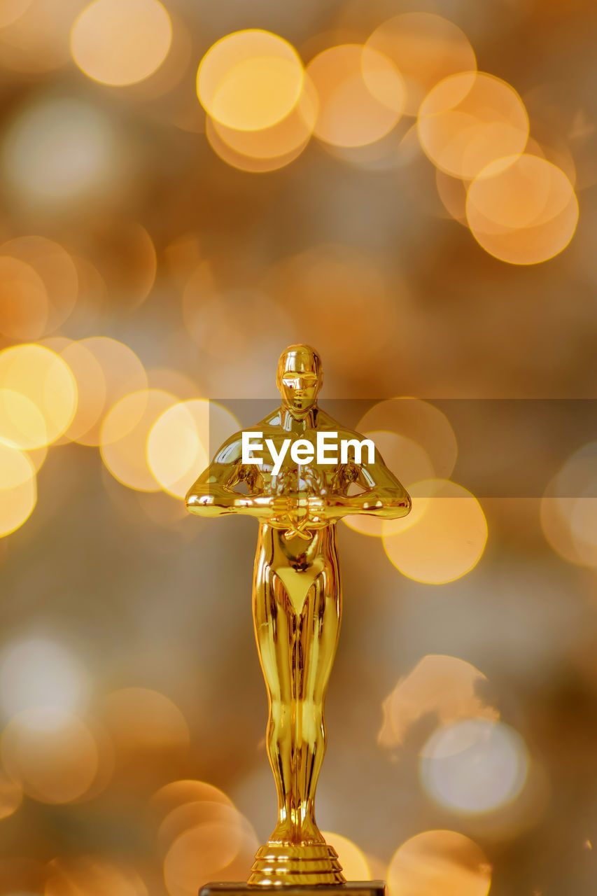 Hollywood gold oscars trophy figurine imitation seen during an award cinema ceremony.