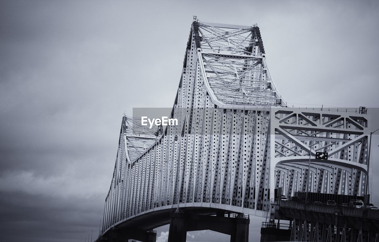 LOW ANGLE VIEW OF BRIDGE TOWER AGAINST CLOUDY SKY