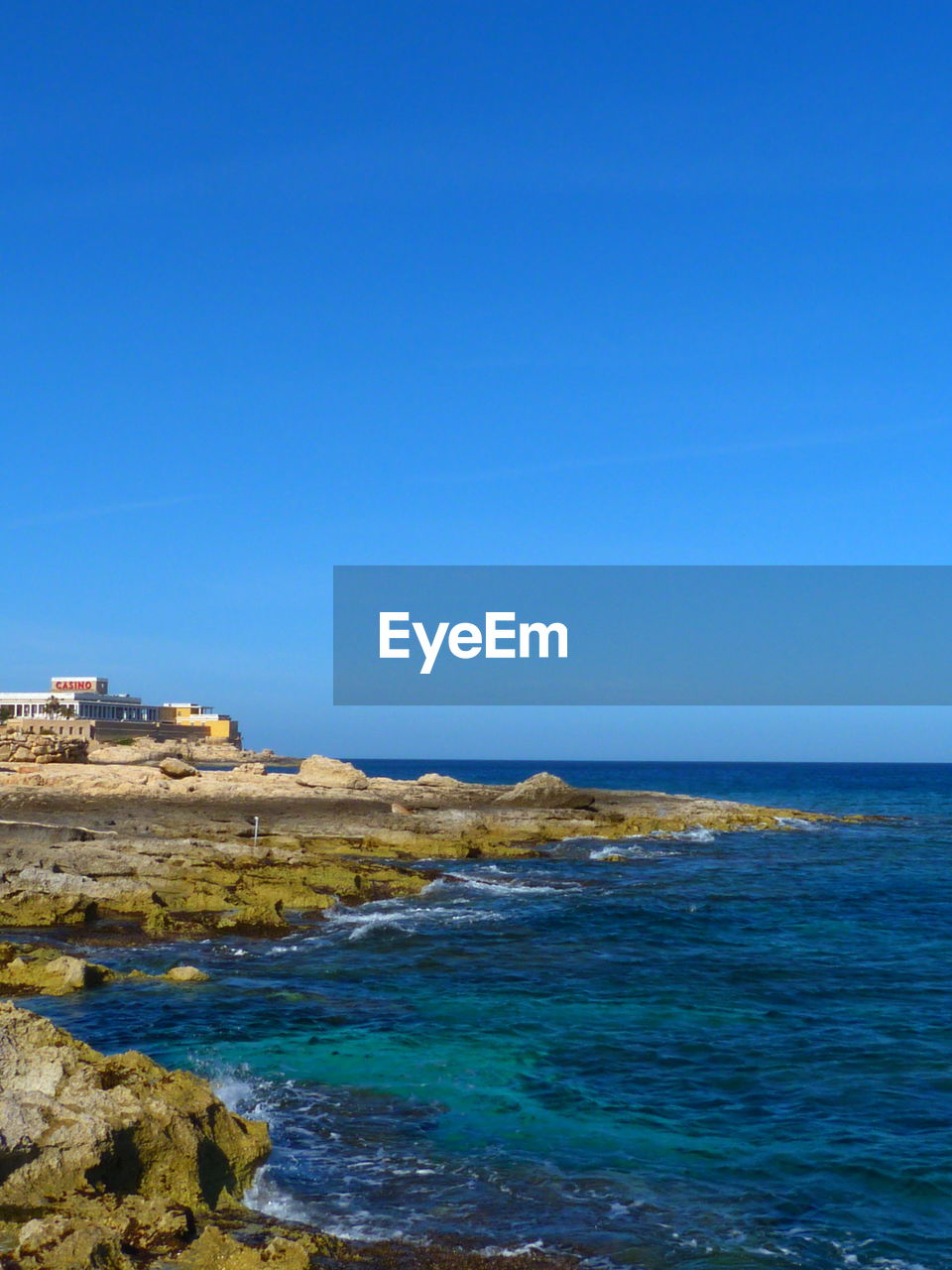 SCENIC VIEW OF BEACH AGAINST CLEAR SKY