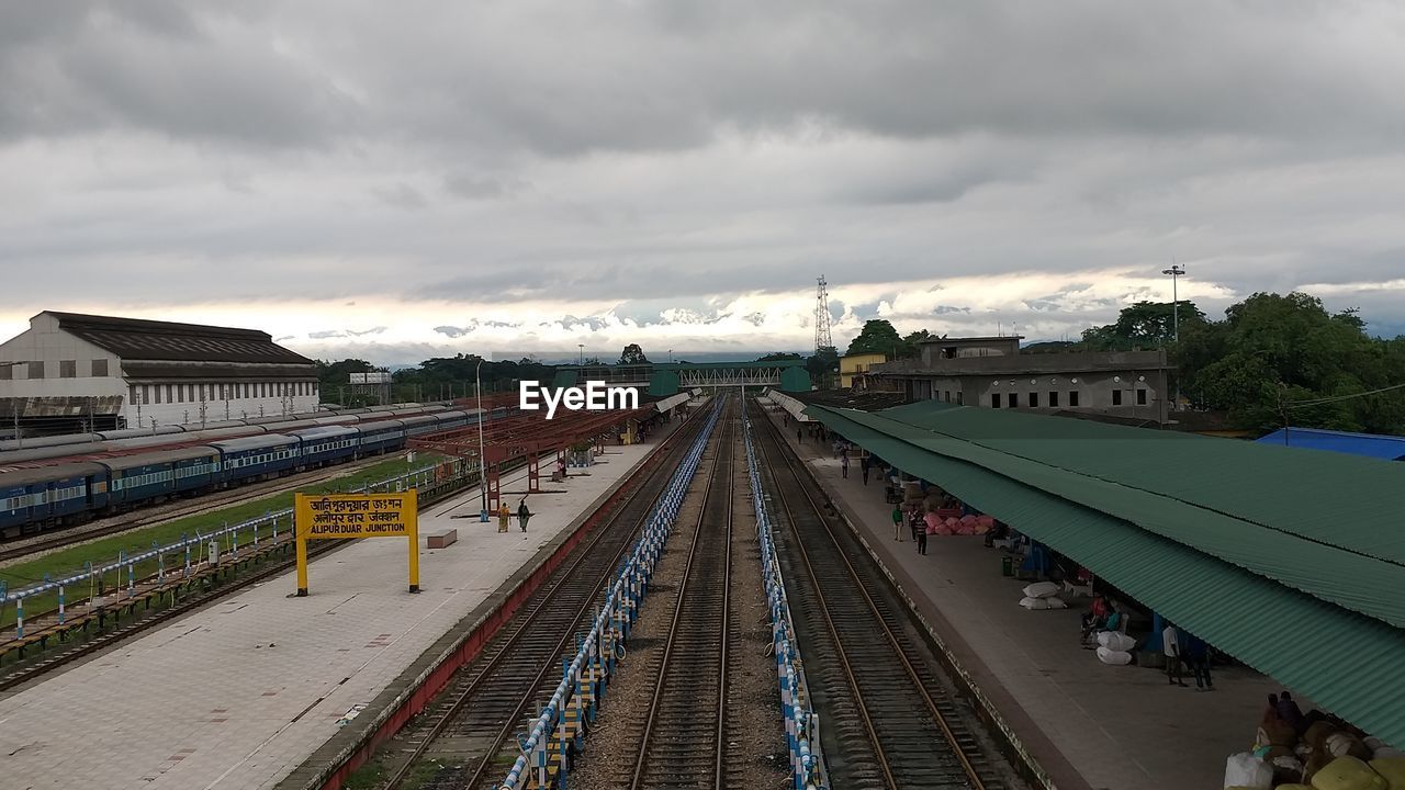 HIGH ANGLE VIEW OF RAILROAD STATION PLATFORM AGAINST SKY