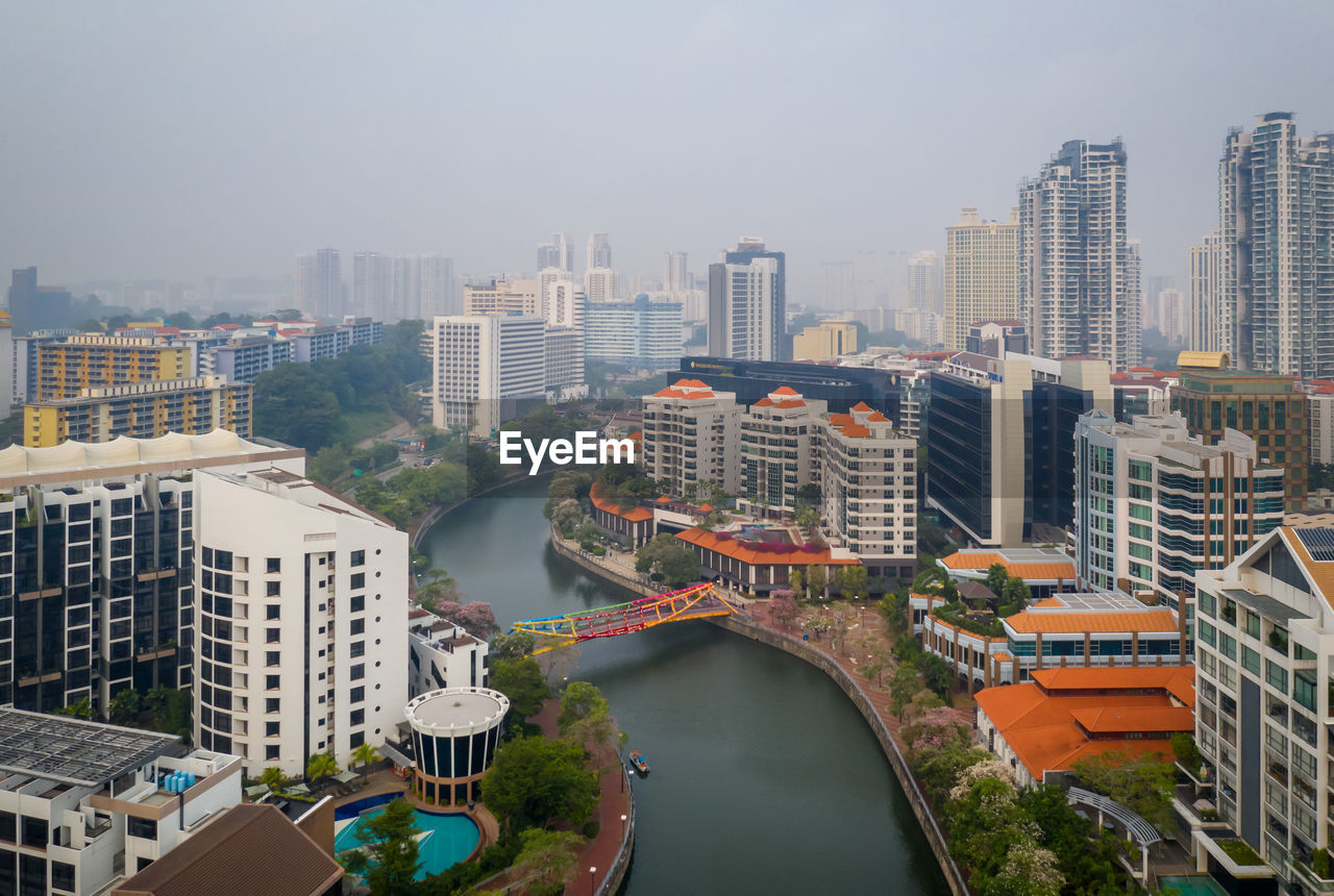 HIGH ANGLE VIEW OF MODERN BUILDINGS AGAINST SKY IN CITY