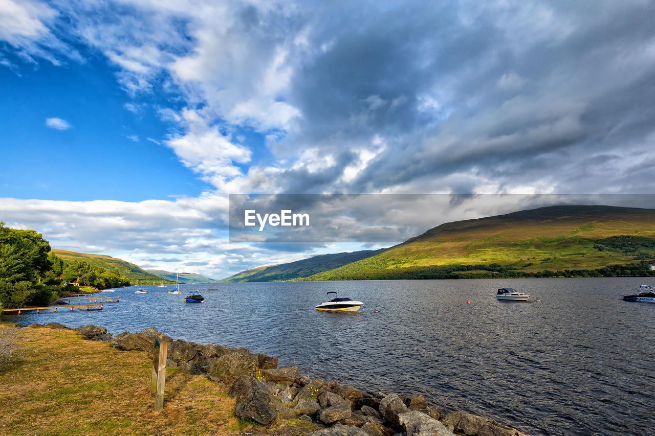 SCENIC VIEW OF BOATS IN RIVER