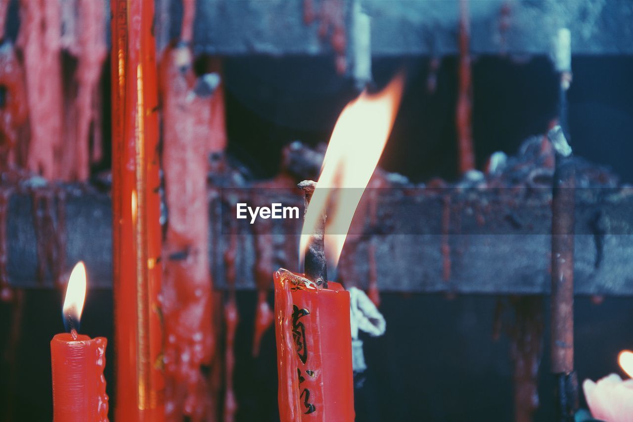 Close-up of burning candles at temple