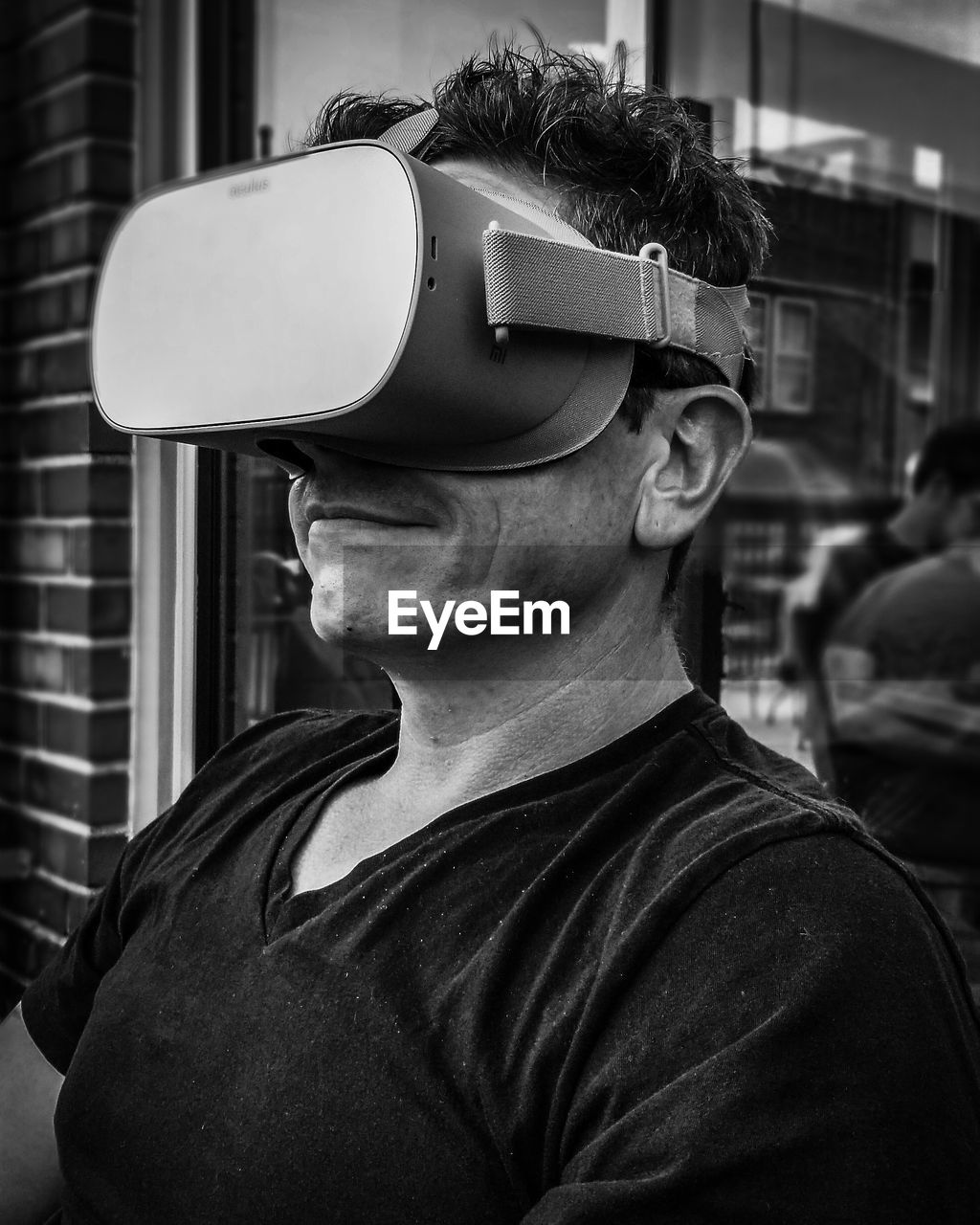 Close-up of young man wearing virtual reality glasses indoor