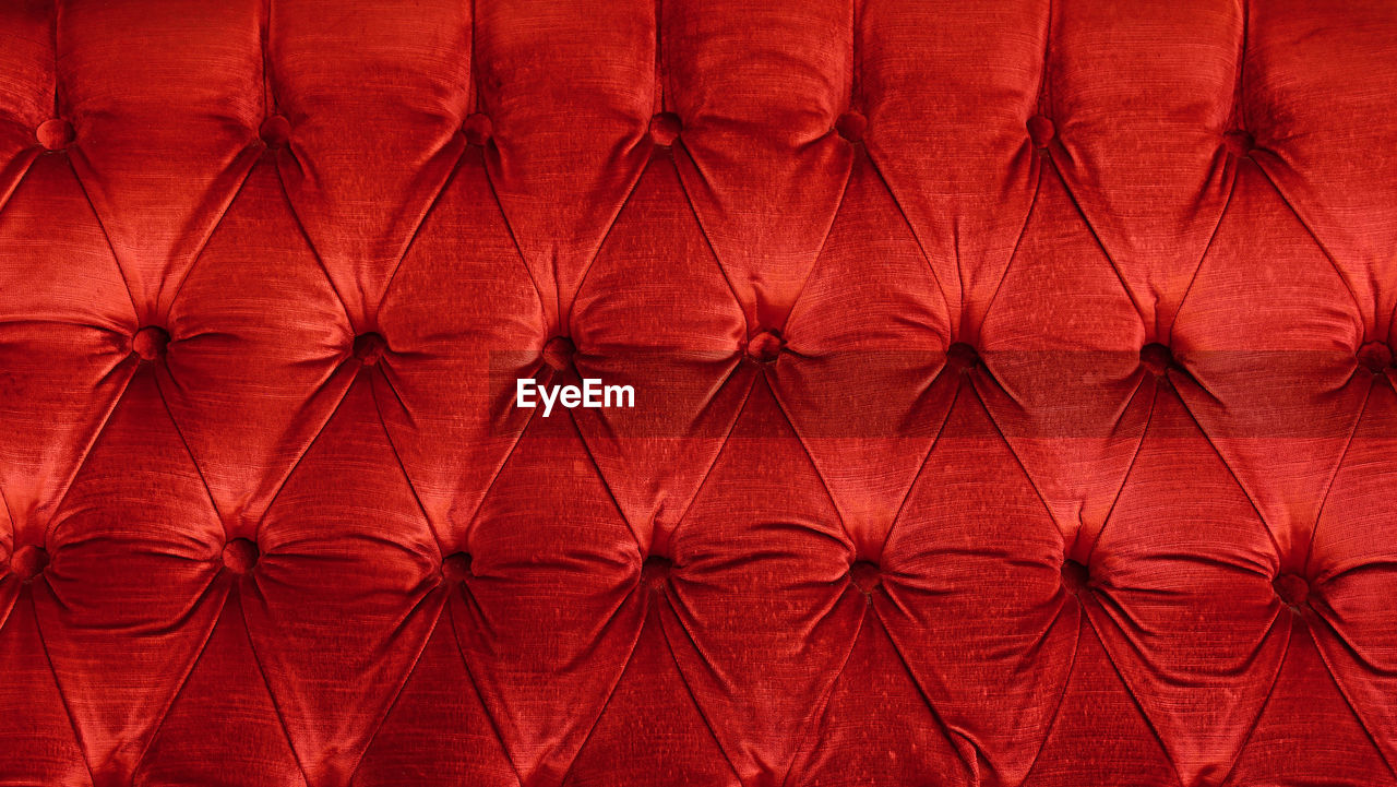 Full frame shot of red velvet sofa