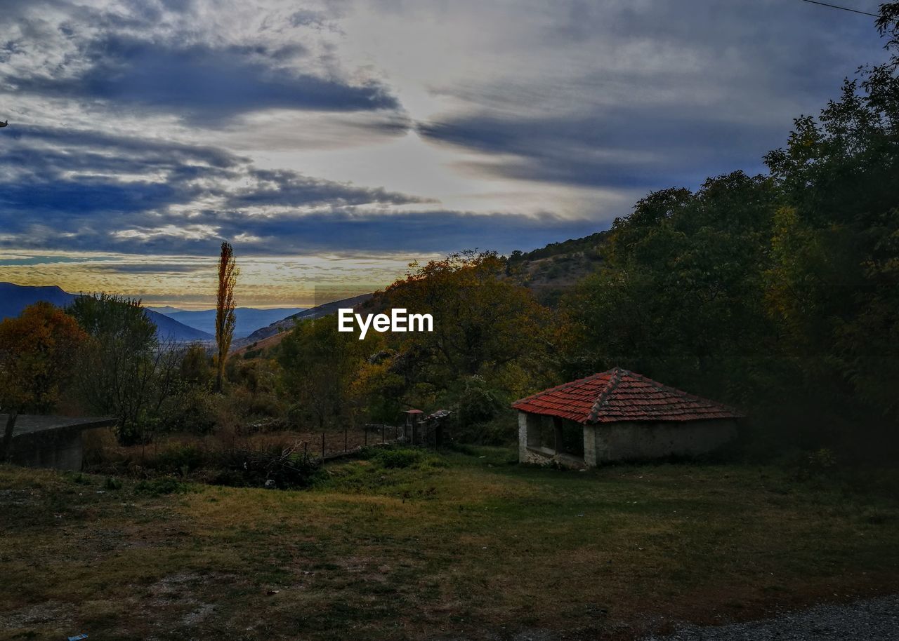 HOUSE ON LANDSCAPE AGAINST SKY