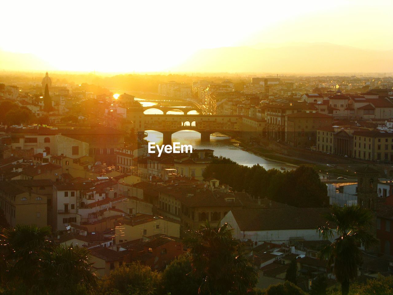 Aerial view of townscape against sky at sunset