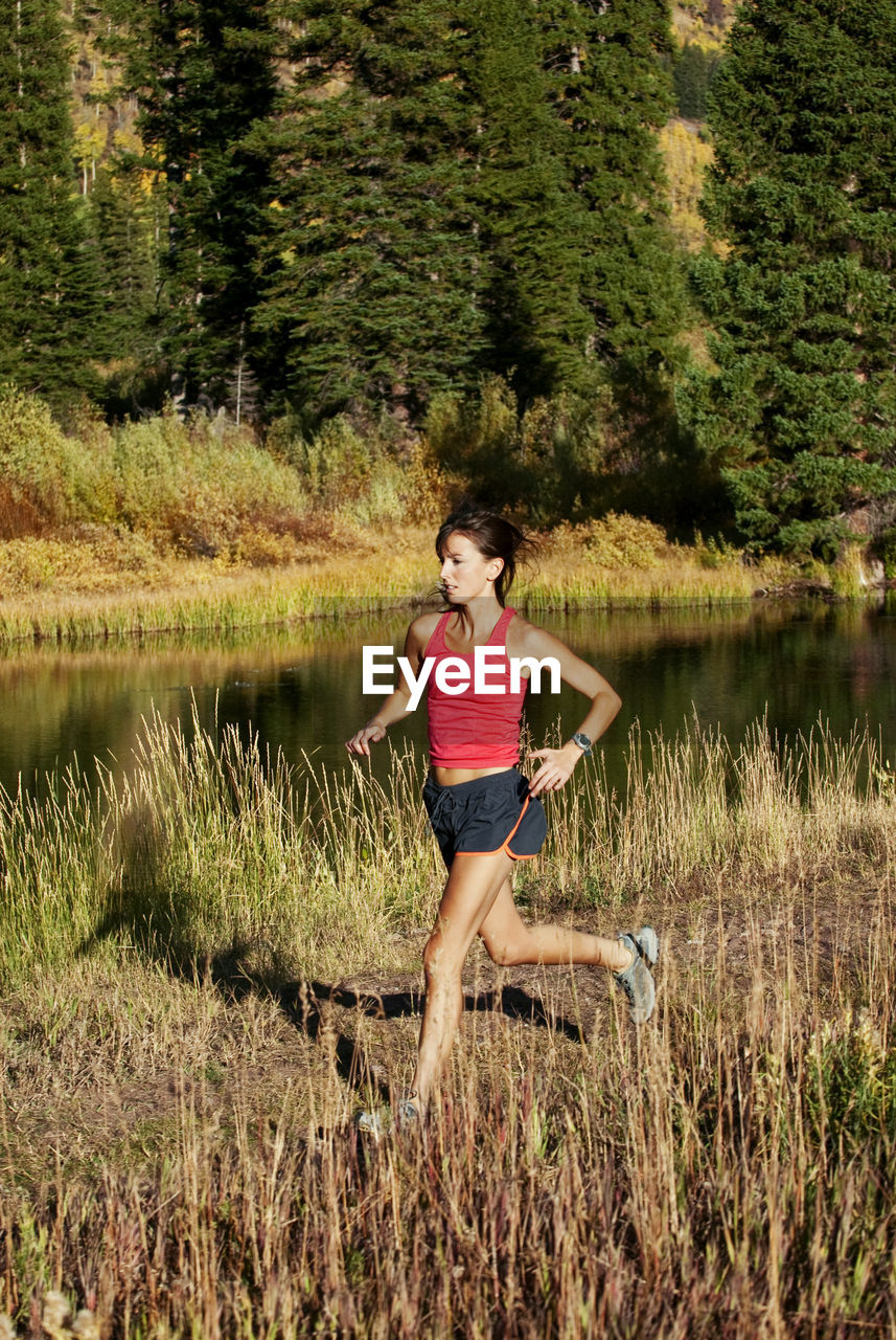 Woman running on lakeshore