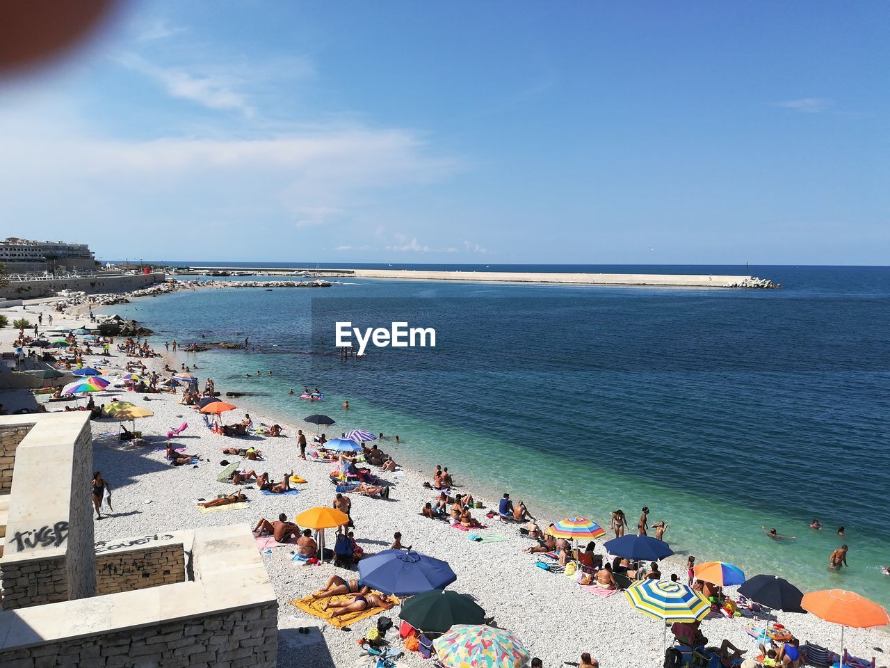 High angle view of people at beach against sky during summer