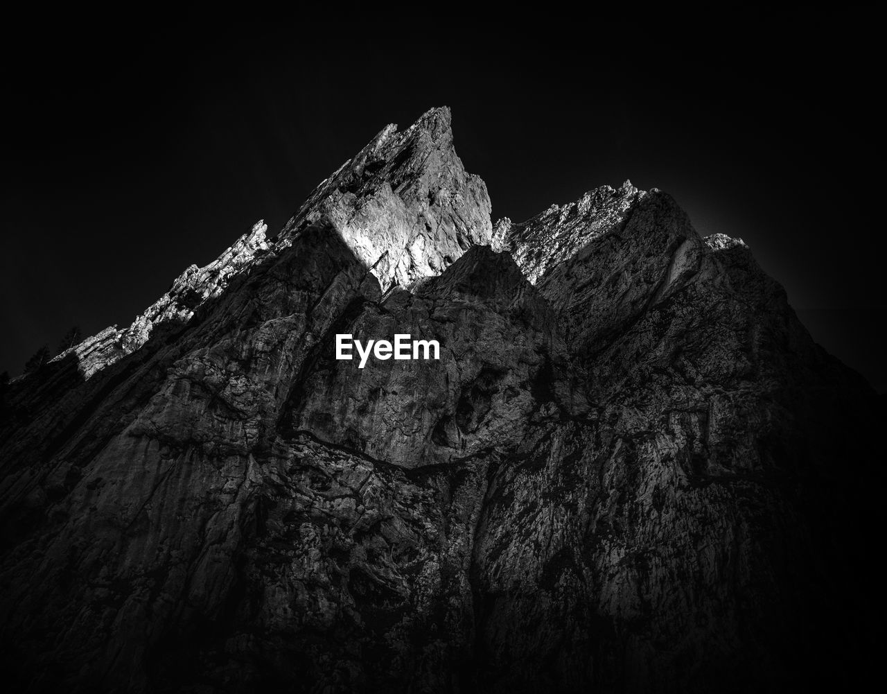 Low angle view of rock formation against sky