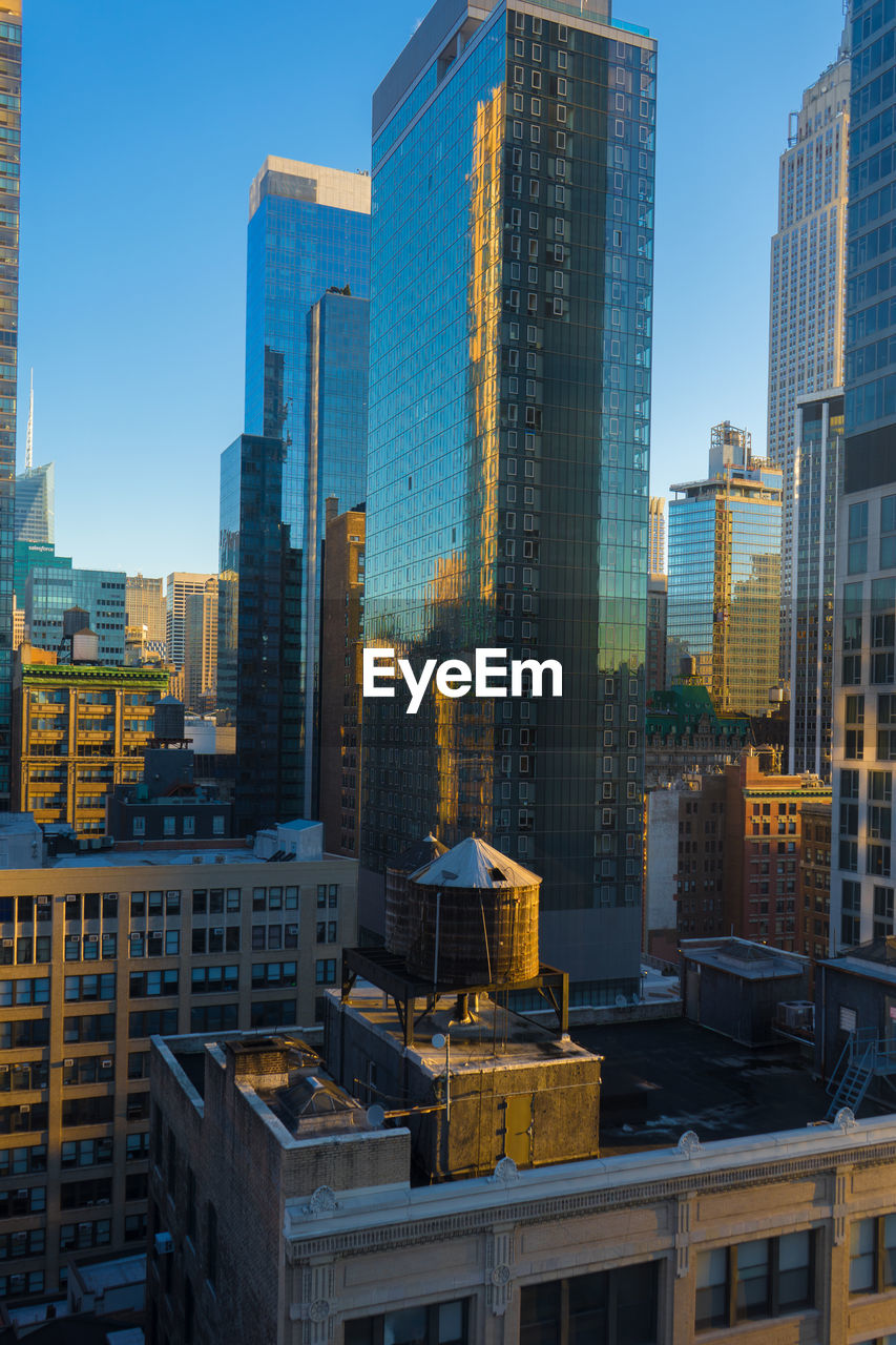 Modern buildings in city against clear sky