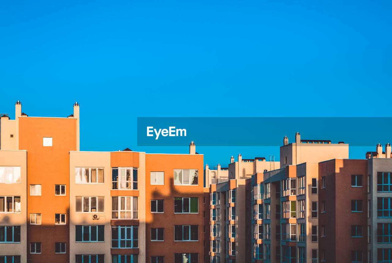 Low angle view of buildings against blue sky