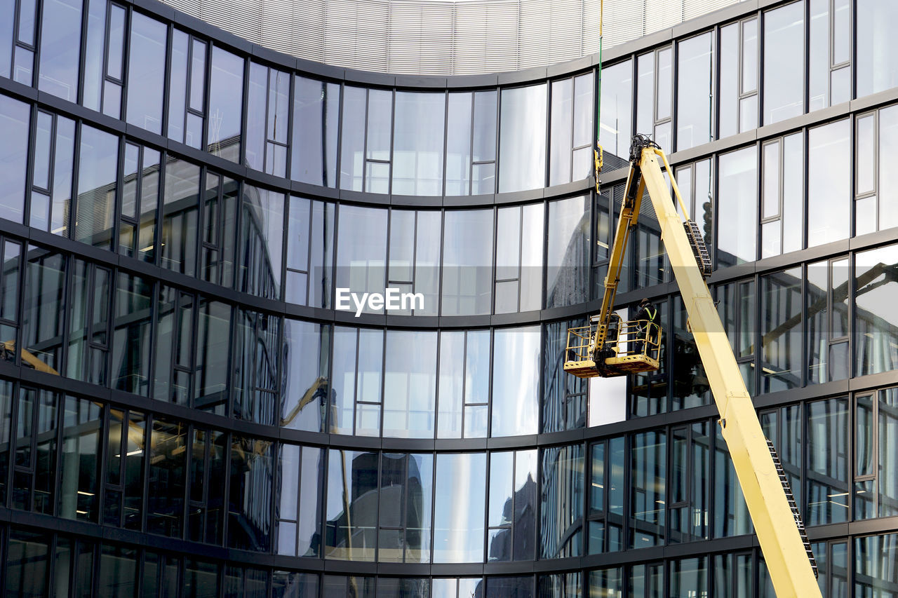 LOW ANGLE VIEW OF MODERN GLASS BUILDING