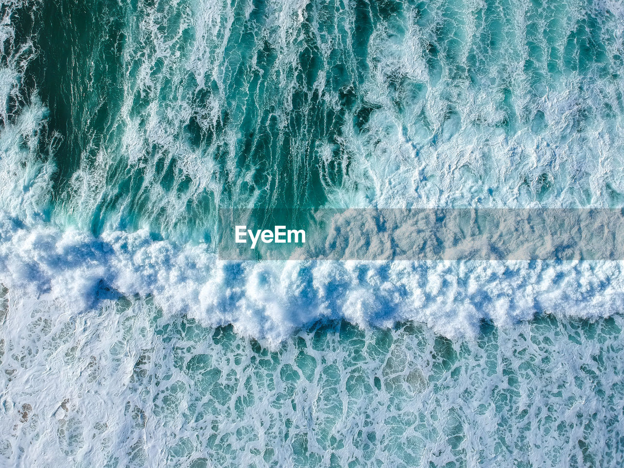 Drone view of beautiful turquiose sea waves breaking on coastline. aerial shot of golden beach 