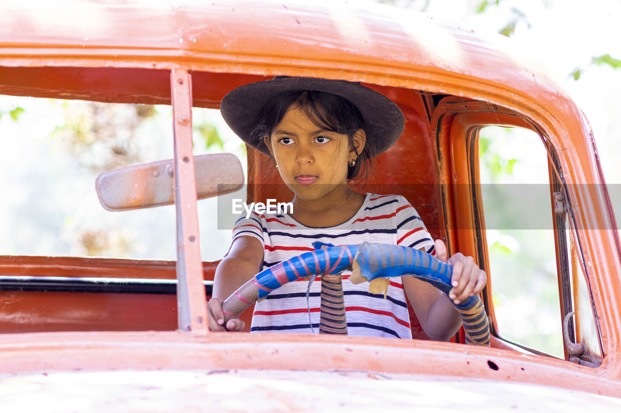 Portrait of boy sitting outdoors