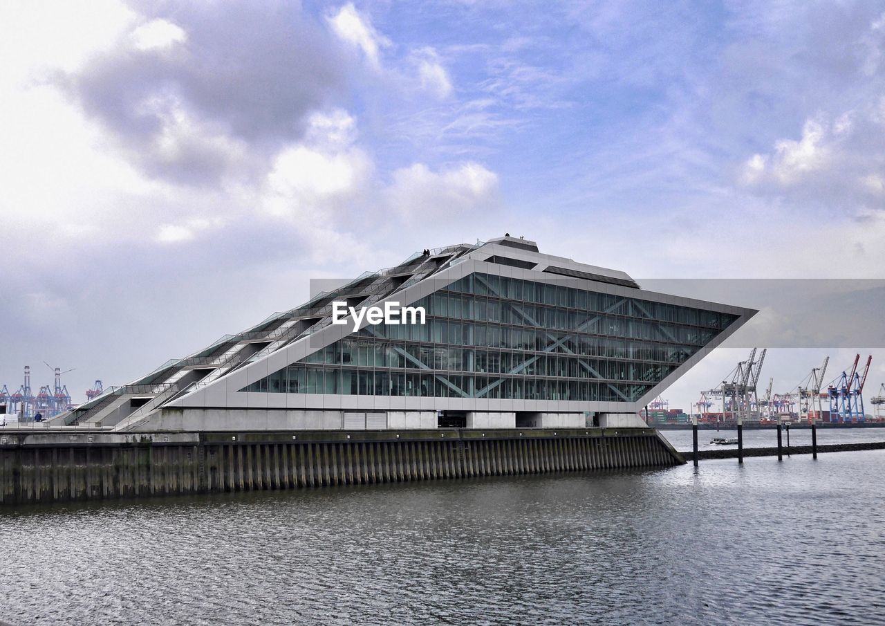 VIEW OF BUILT STRUCTURES AGAINST CLOUDY SKY