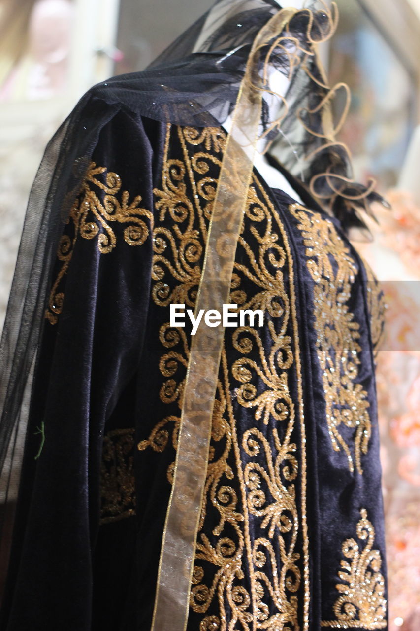CLOSE-UP OF CLOTHES HANGING ON STORE
