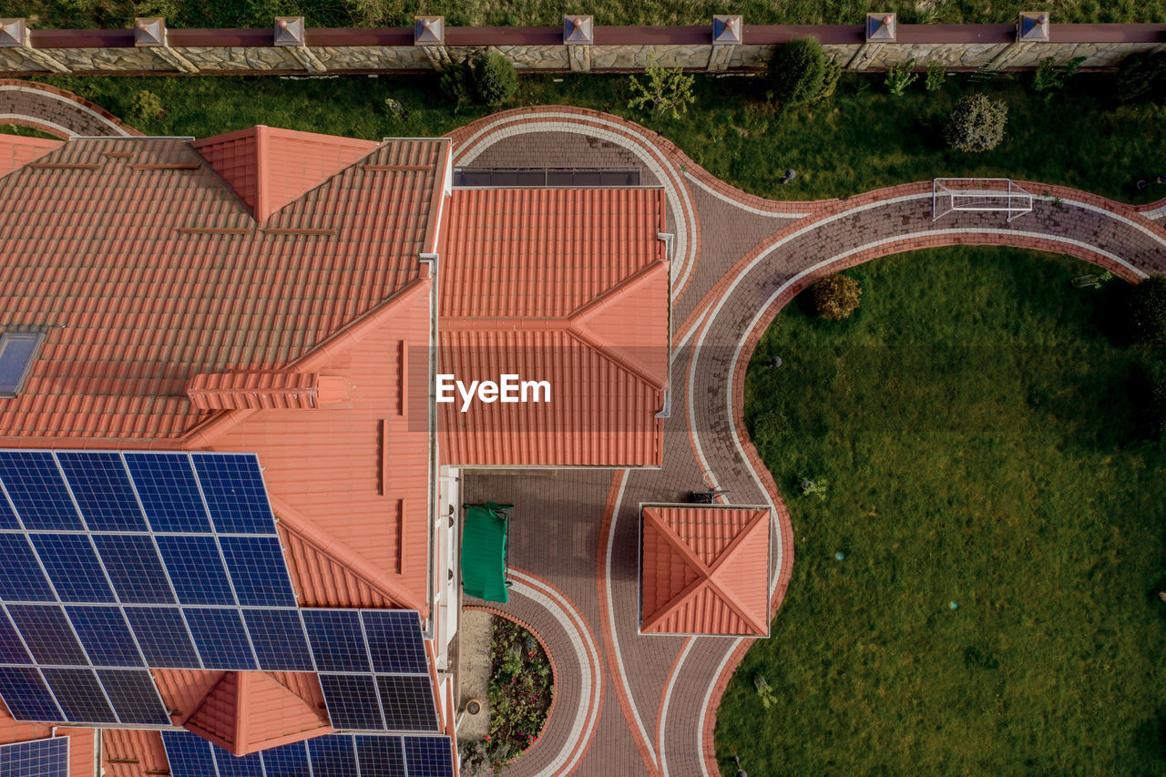 HIGH ANGLE VIEW OF PLANTS ON FIELD AGAINST BUILDINGS