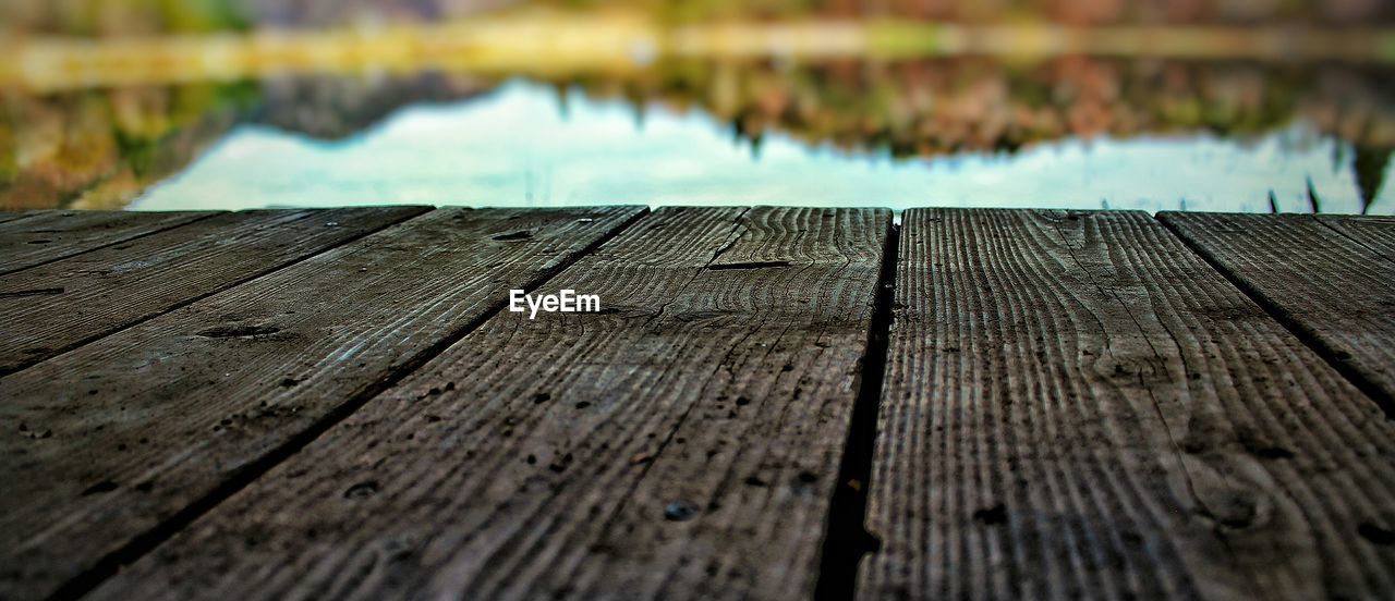 Wooden planks on pier against lake