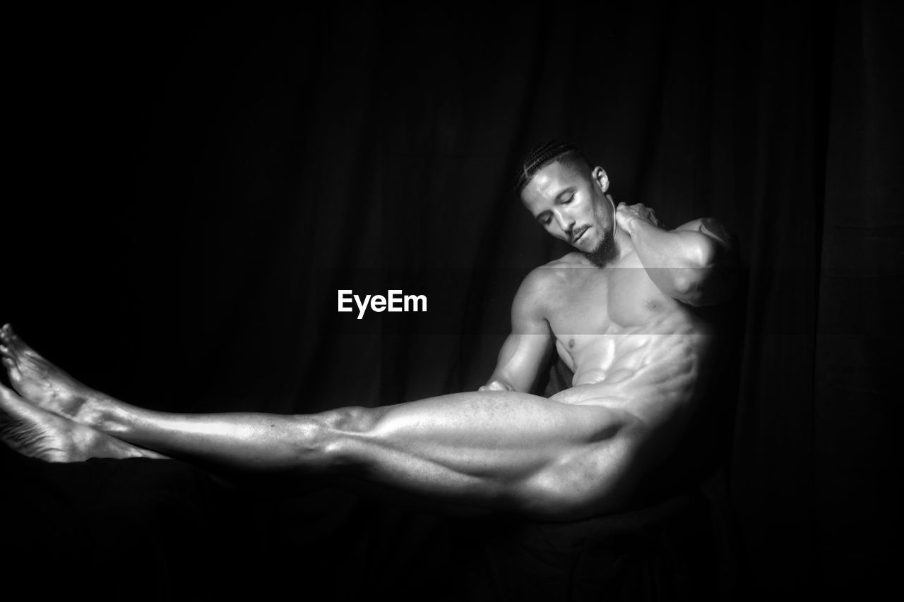 black and white, muscular build, adult, one person, strength, indoors, monochrome photography, exercising, black, studio shot, lifestyles, young adult, black background, athlete, sports, arm, men, monochrome, portrait, darkness, vitality, wellbeing, sports training, performance art, copy space, human face, human muscle, person, dancing