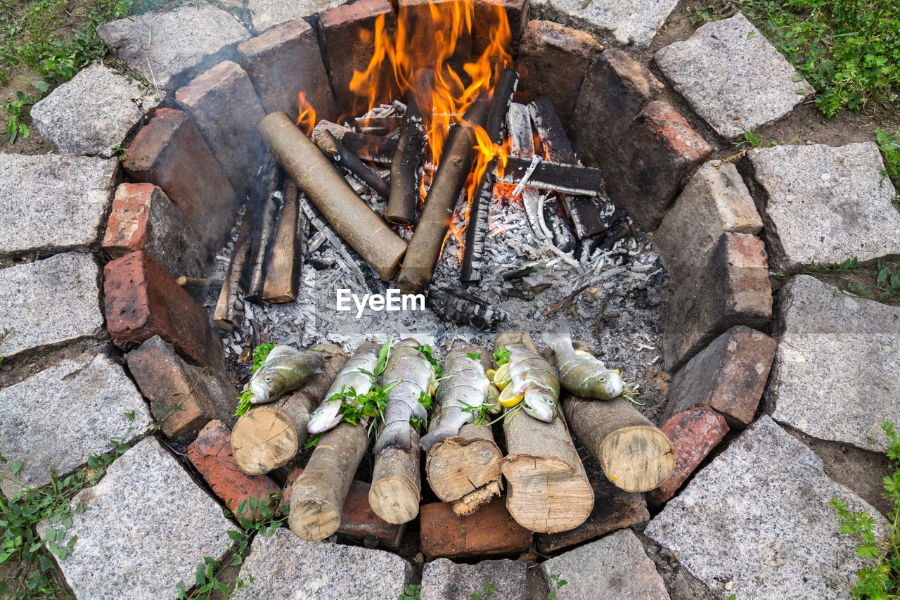 HIGH ANGLE VIEW OF FIREWOOD ON BARBECUE