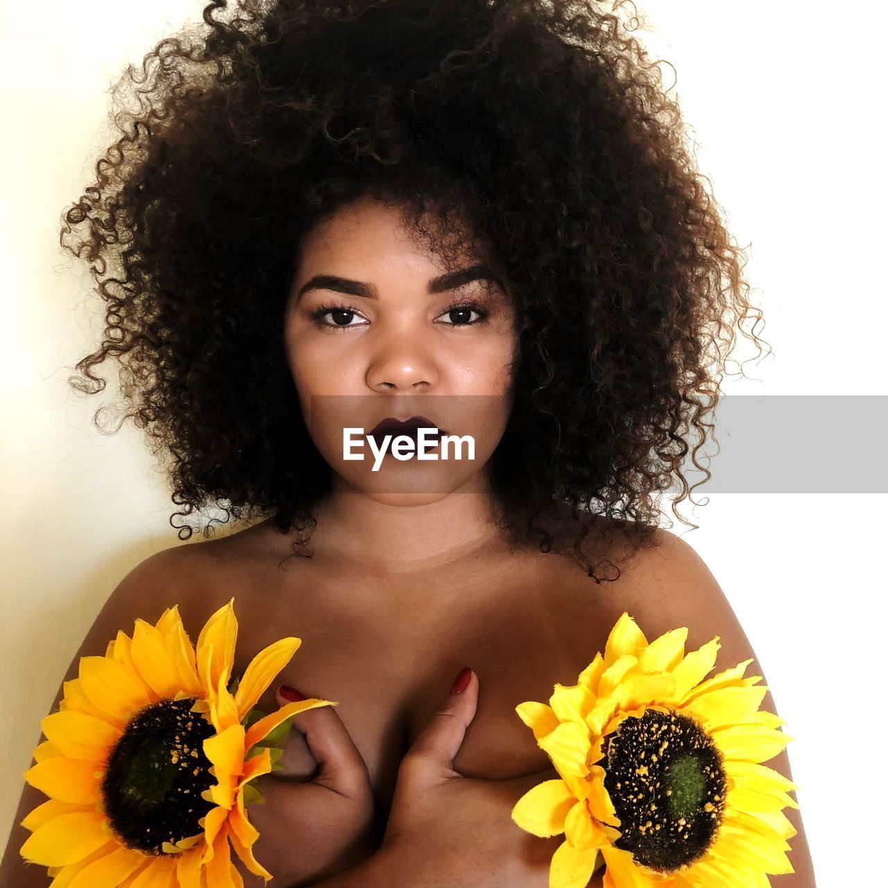 PORTRAIT OF A BEAUTIFUL YOUNG WOMAN AGAINST YELLOW BACKGROUND