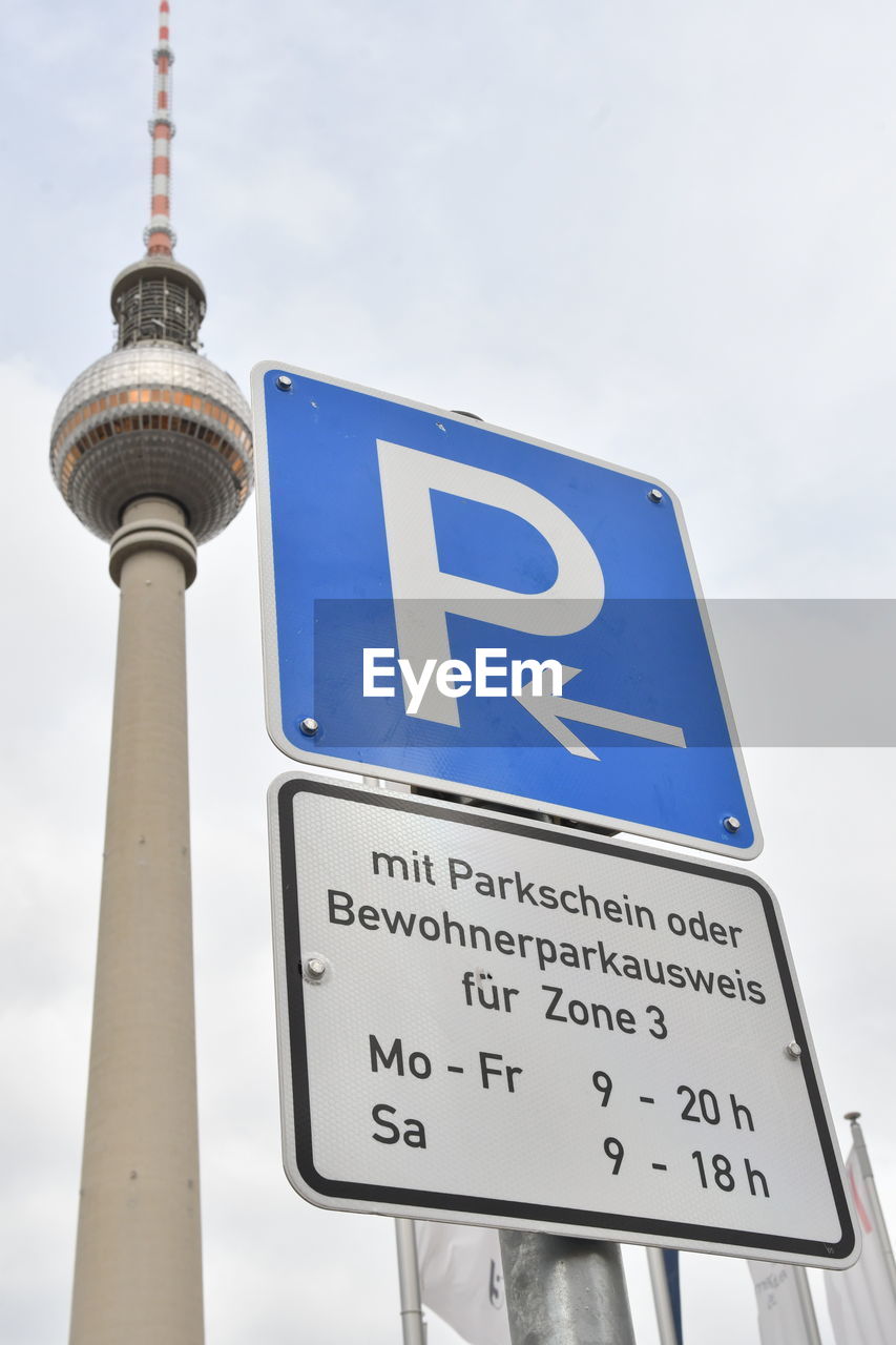 LOW ANGLE VIEW OF SIGN BOARD AGAINST SKY