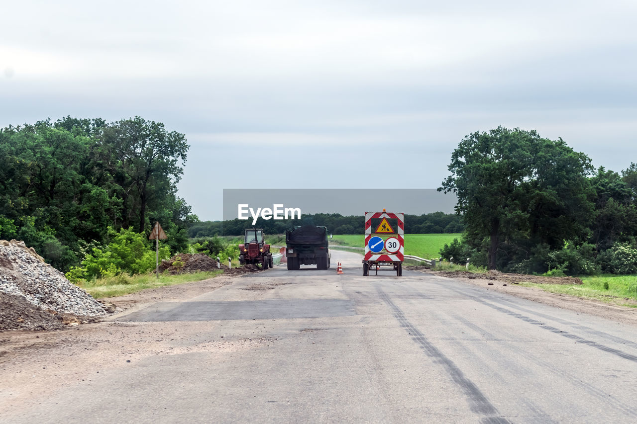 Vehicles on road against sky