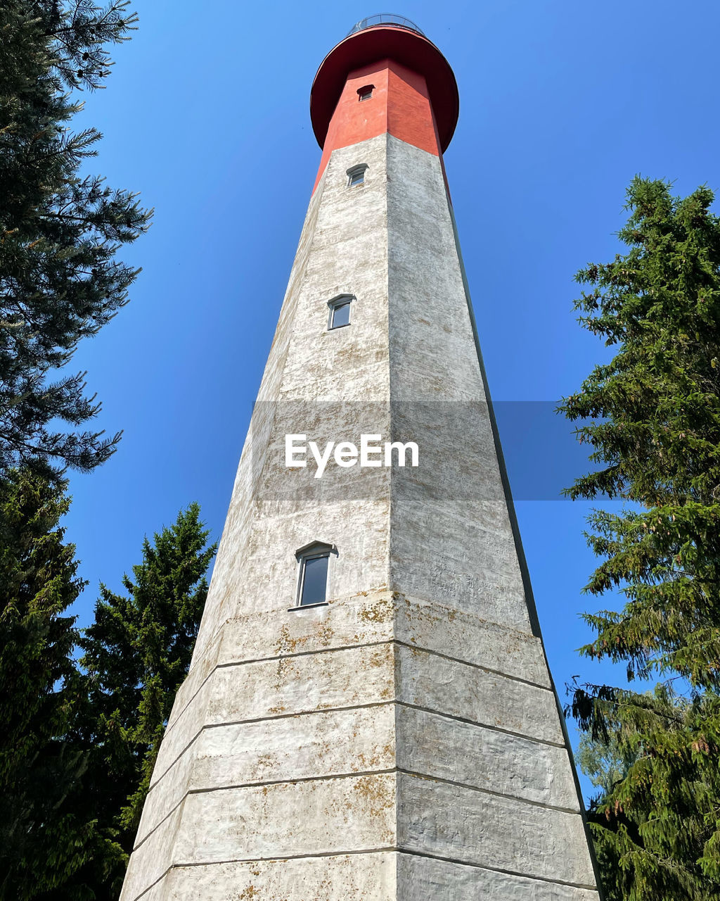 LOW ANGLE VIEW OF LIGHTHOUSE AGAINST SKY AND TREES