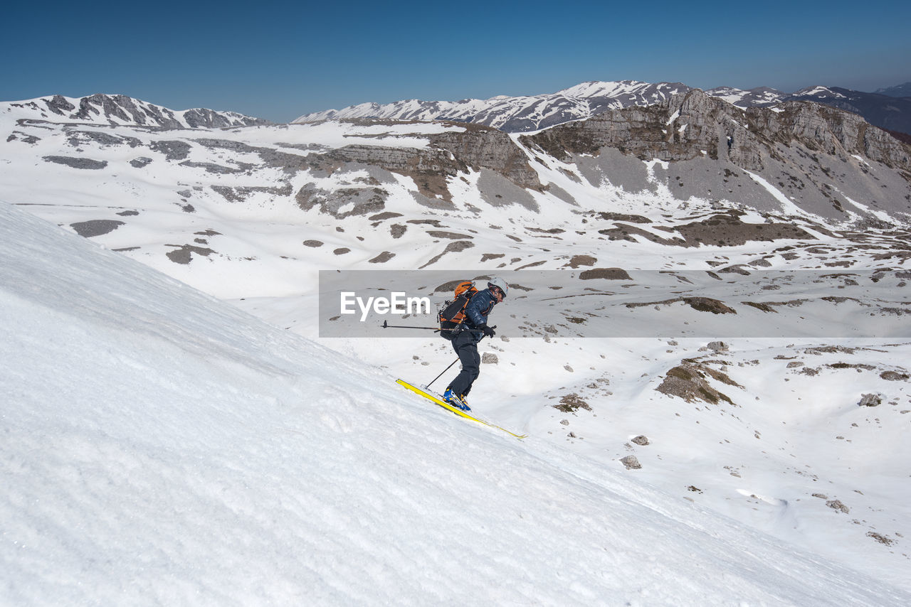 Man skiing on snow covered mountain