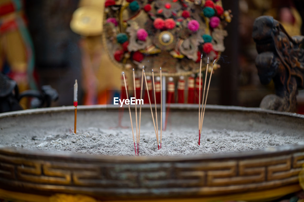 Close-up of lit candles in temple