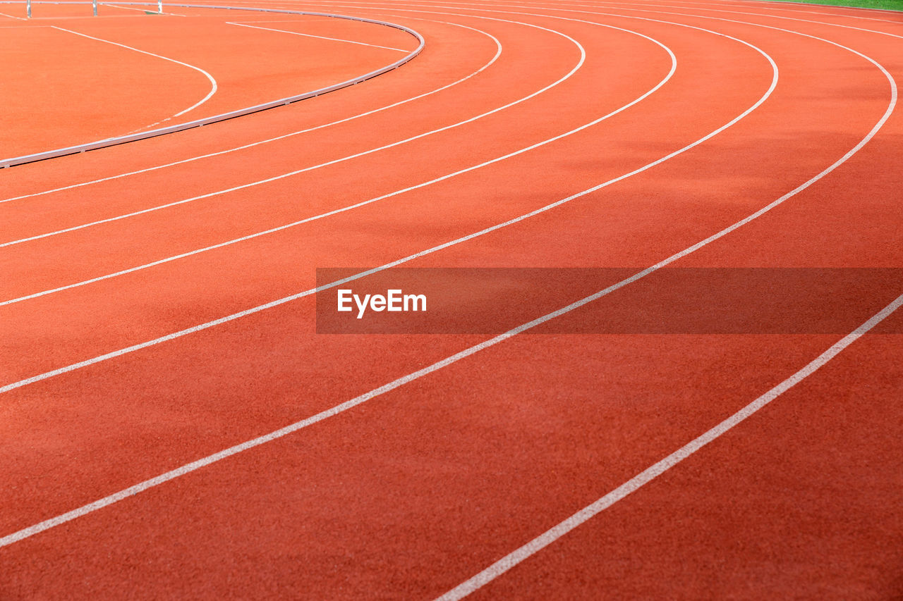 Full frame shot of orange track and field